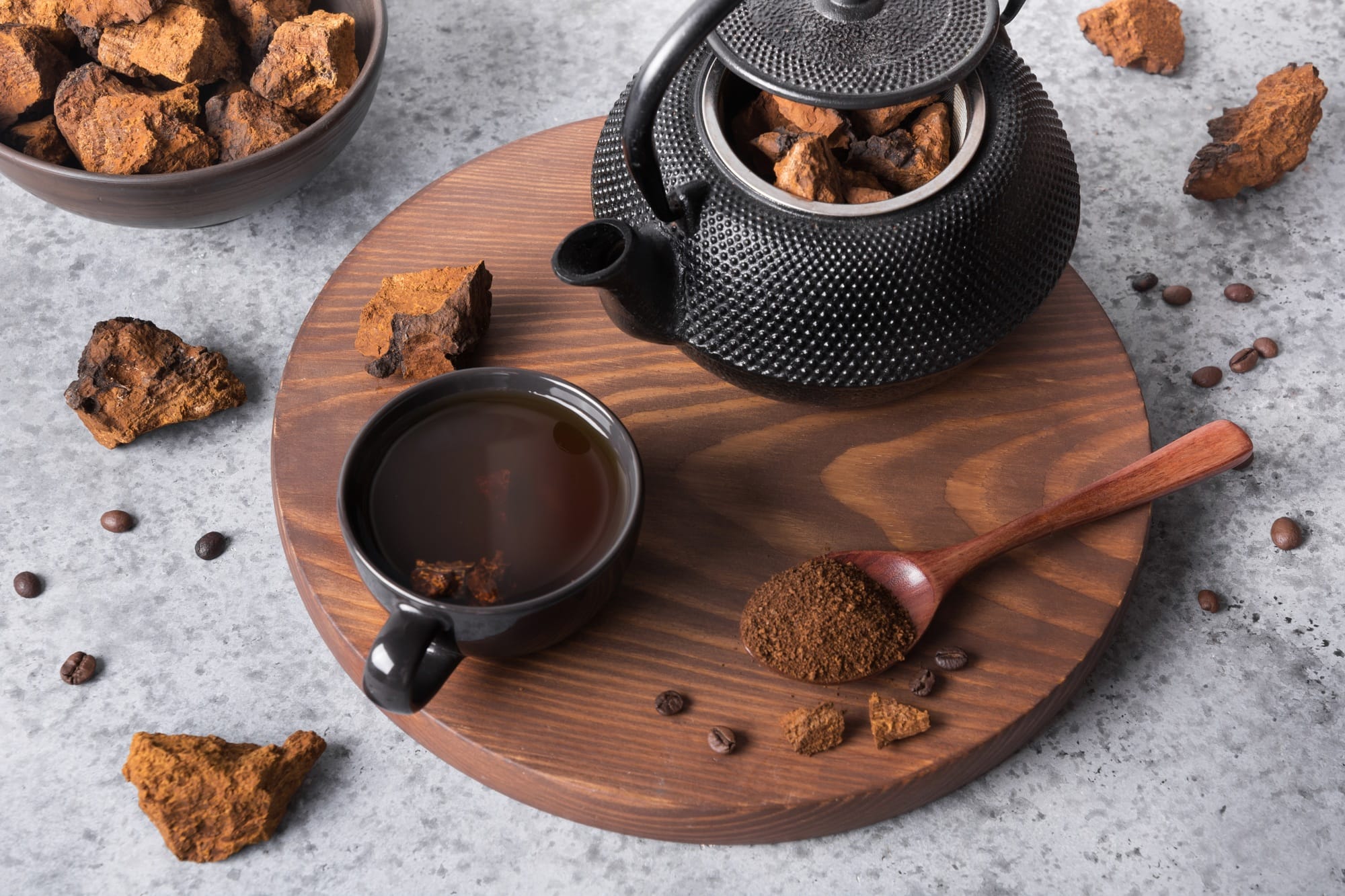 Chaga mushroom slicing and preparation for making healthy coffee drink in teapot.